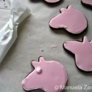 Peppa Pig cookie with pink icing base, a dot of white icing added for the eye.