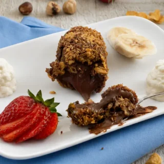 Crispy Nutella dessert cut open with a warm chocolate-hazelnut centre.
