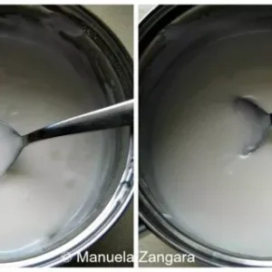 Making glassa fondente glaze in a pot until smooth and creamy white.