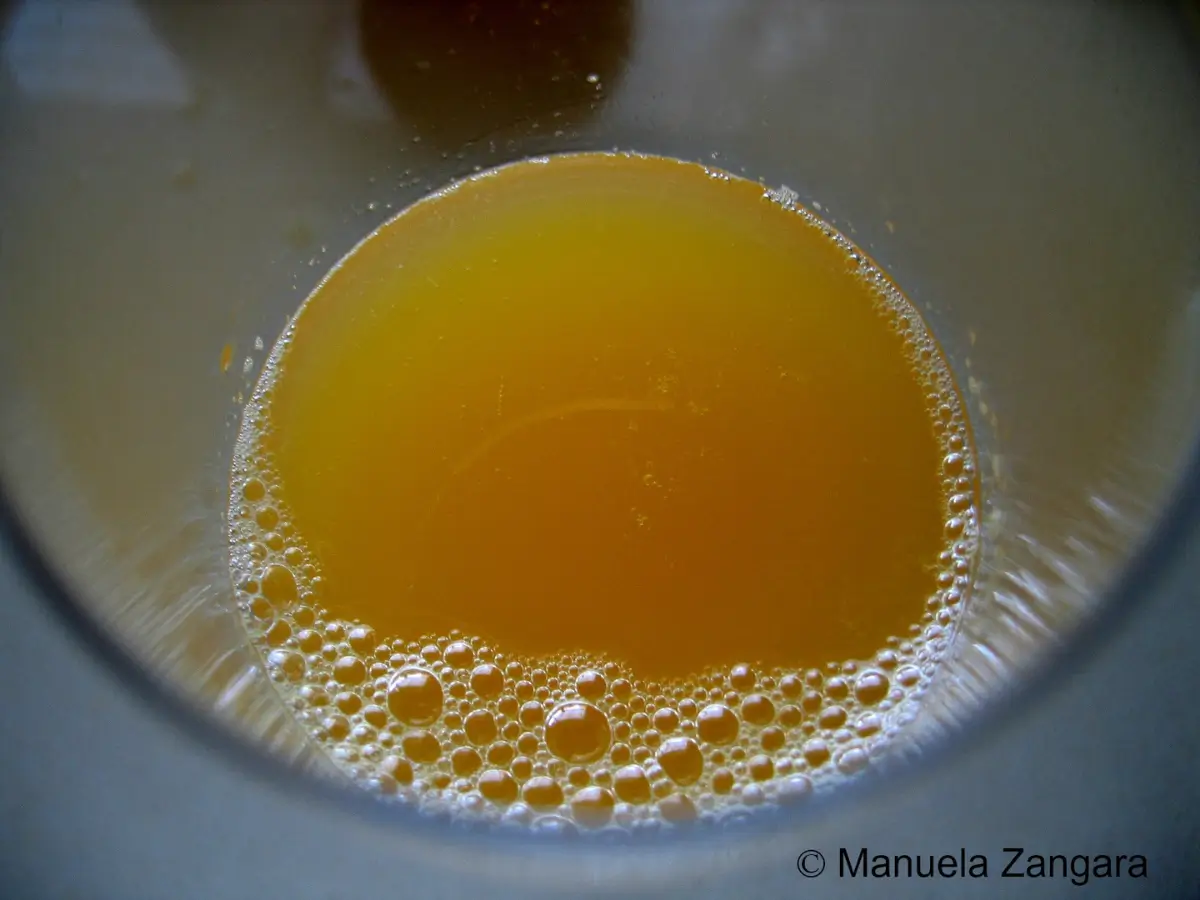 Freshly squeezed orange juice settled at the bottom of a glass.
