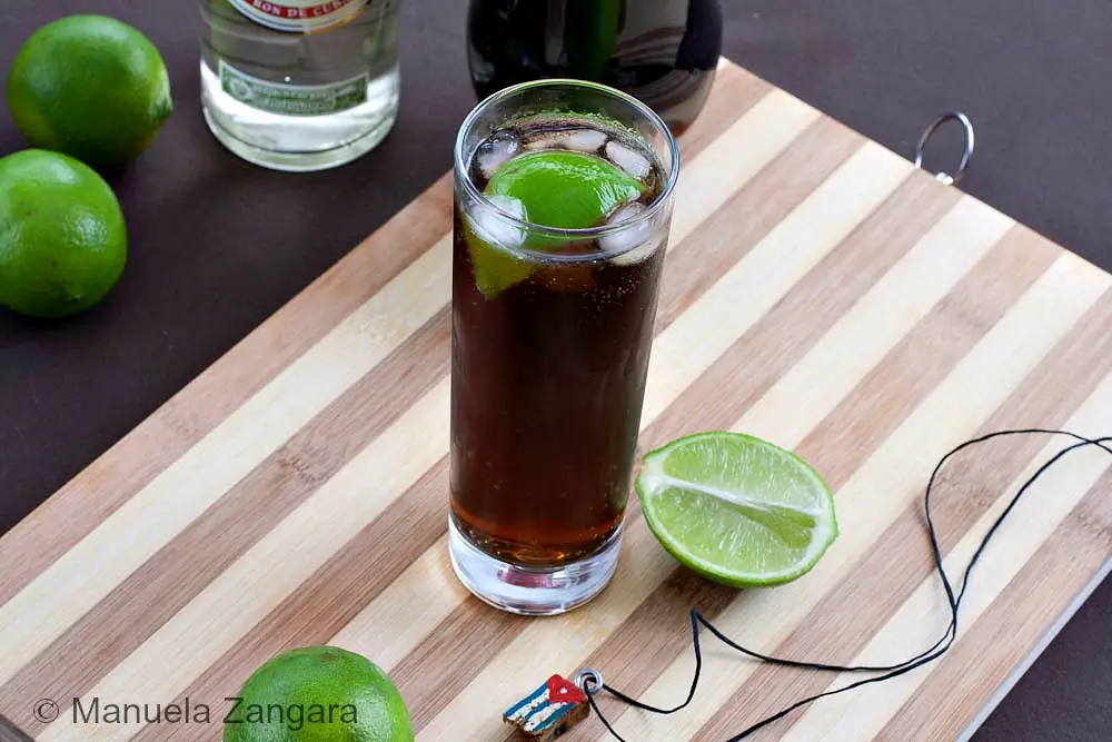 Close-up of a Cuba Libre with lime and ice.