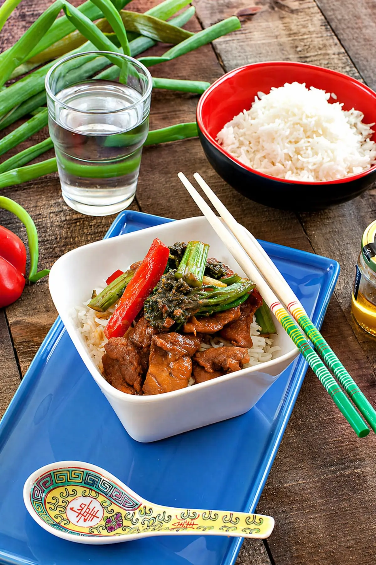 Ginger pork served over steamed rice with broccolini and red capsicum.