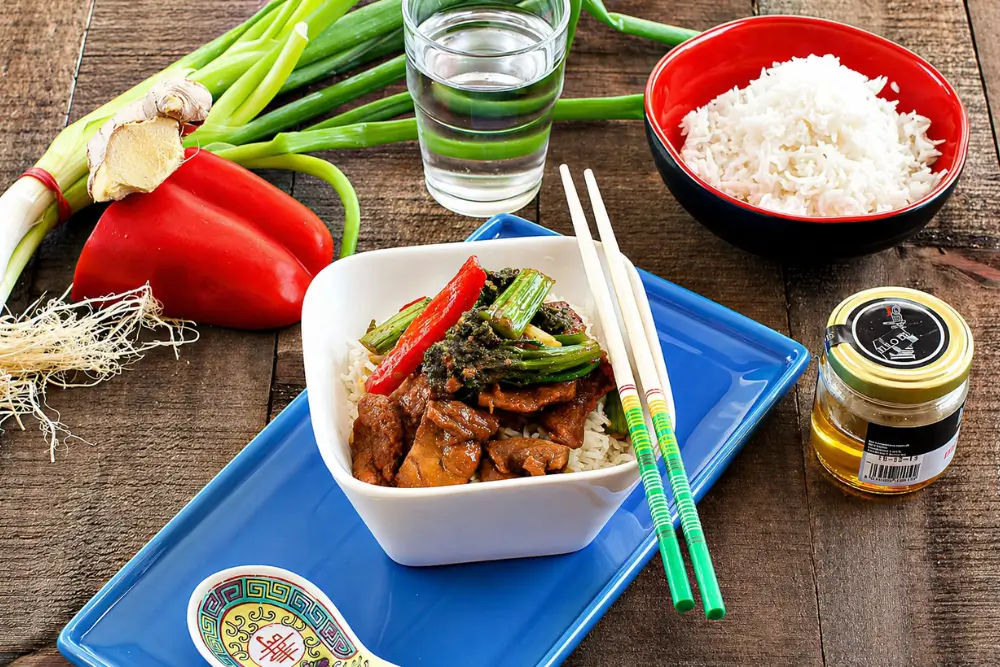 Sweet soy pork served with steamed rice, broccolini, and red capsicum.