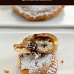 Fried cassatella dusted with icing sugar and filled with ricotta and chocolate.