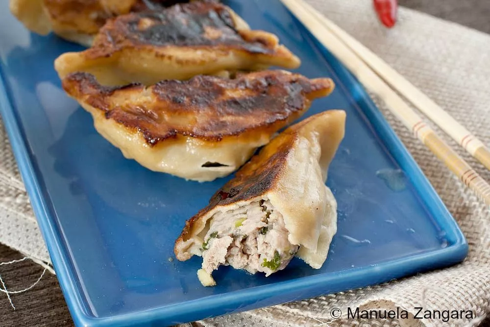 Close-up of Kothey Momo showing juicy pork filling inside a crispy dumpling.