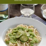 Bowl of trofie pasta topped with zucchini cream sauce.