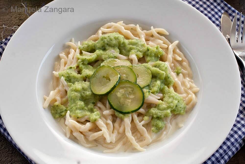 Plate of trofie pasta with Taleggio fondue and zucchini cream.