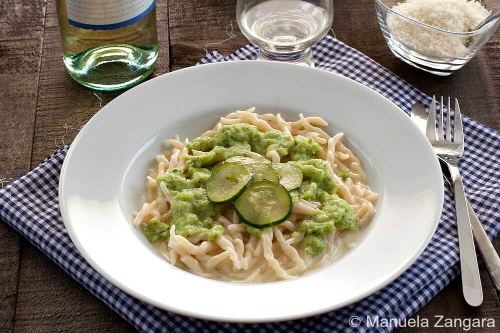 Bowl of trofie pasta topped with zucchini cream sauce.