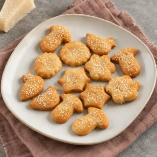 Baked cheese cookies with sesame seeds served on a plate.