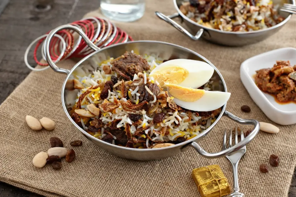Bowl of spiced rice with tender lamb pieces, sultanas, and crispy onions.