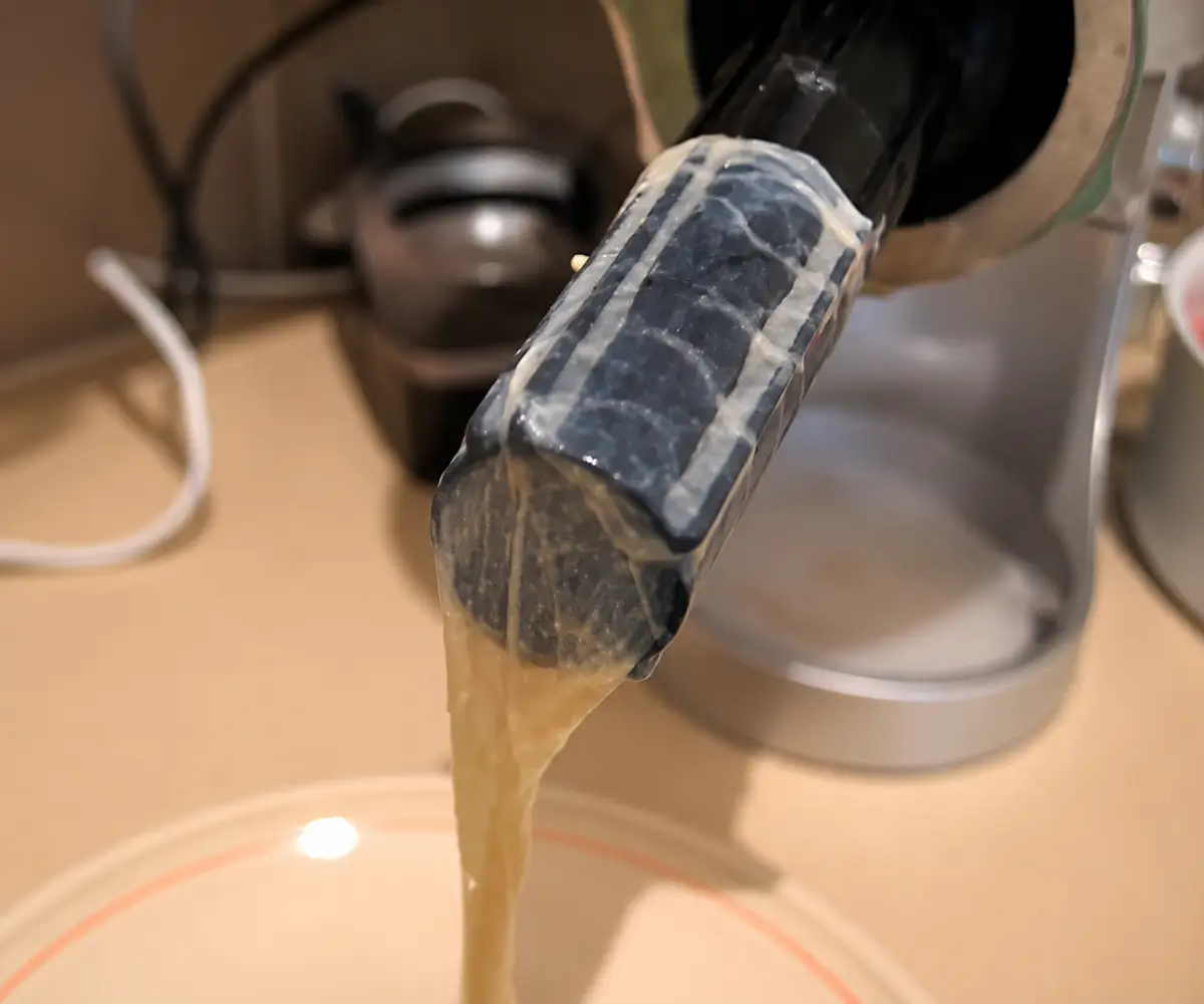 Edible sausage casing fitted onto a sausage stuffer tube before filling.