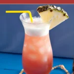A tall glass of Mai Tai filled with ice and topped with a frothy pineapple layer.