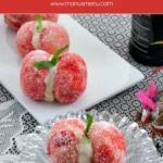 Sugar-coated Pesche Dolce with ricotta filling and mint leaf.