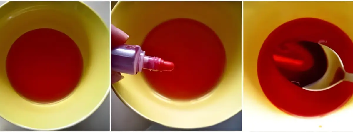 Bowl of red Alchermes syrup with food colouring being mixed.