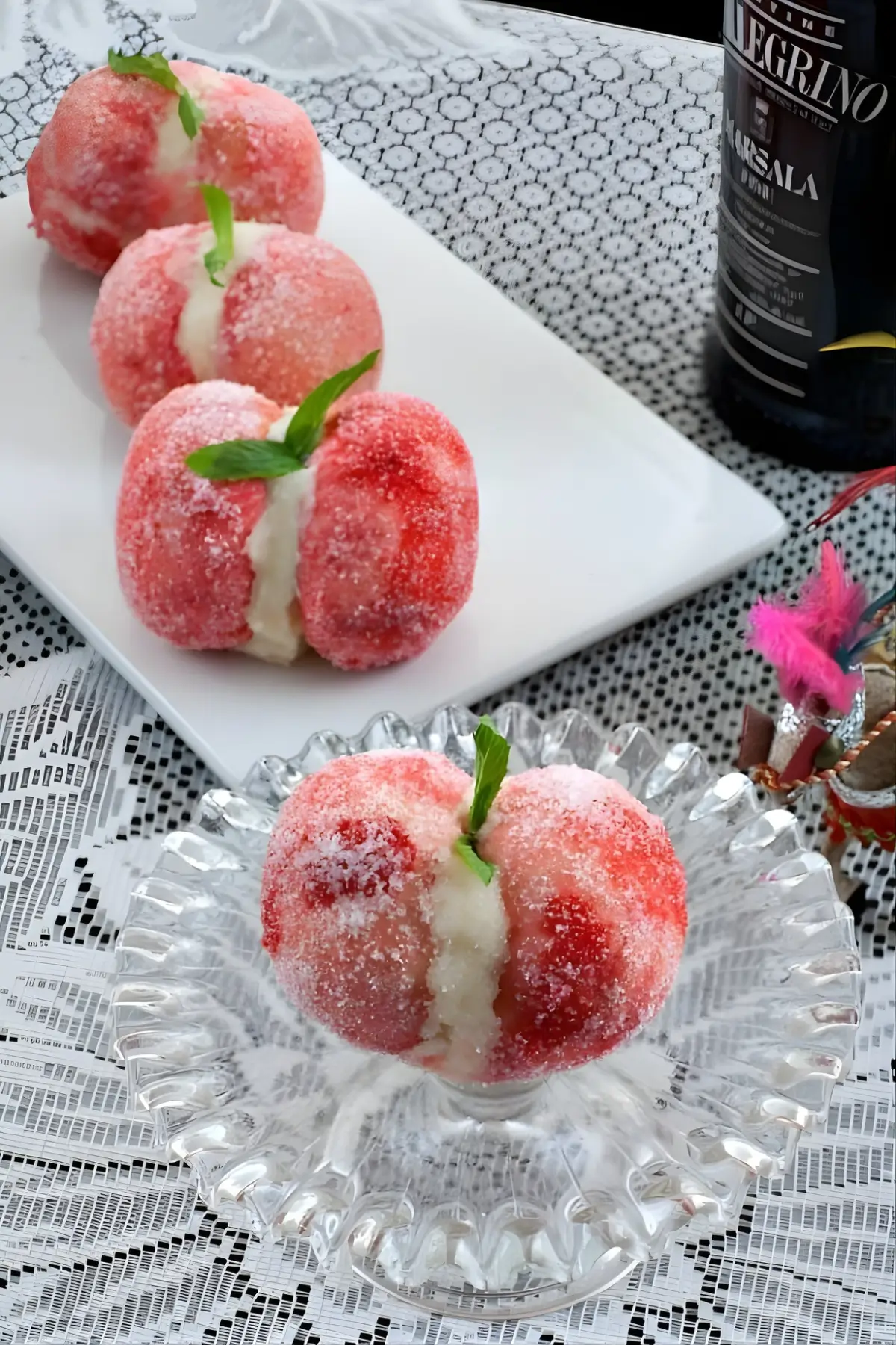 Finished Pesche Dolci alla Siciliana arranged on a plate with mint leaves on top.