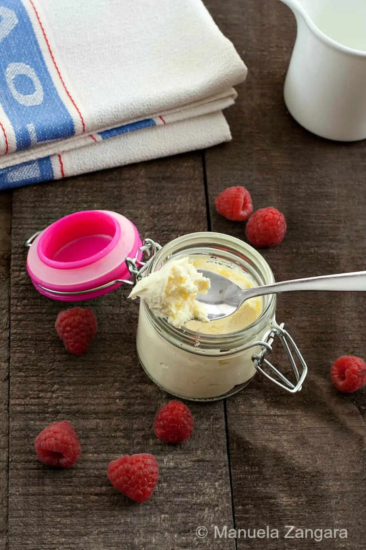 Close-up of smooth mascarpone texture on a spoon.