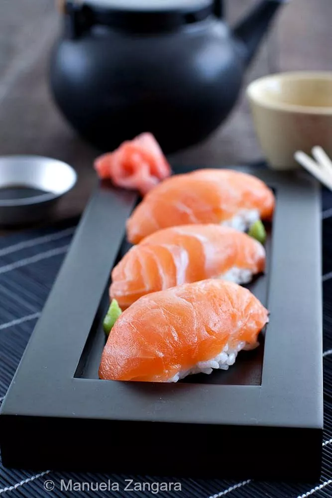 Close-up of Salmon Nigiri with glossy salmon slices over seasoned sushi rice.