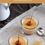 Close-up of caramel panna cotta with a caramel-dipped hazelnut on top.