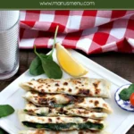 Spinach and feta gozleme sliced and stacked on a plate.