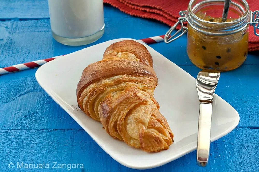 Freshly baked croissants with golden crust and flaky layers.