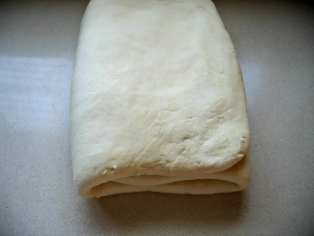 Croissant dough folded into a neat rectangle after the first lamination turn.