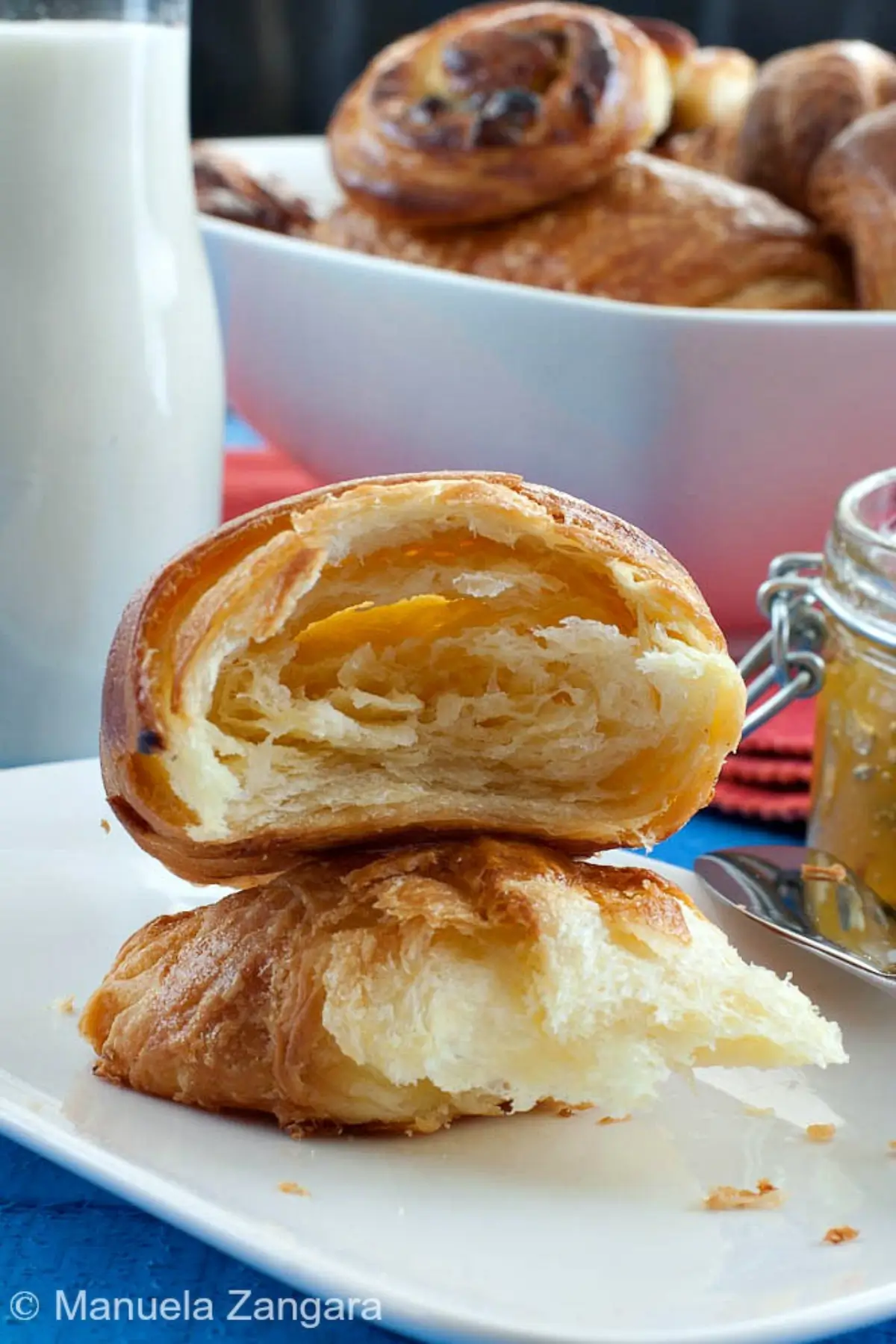 Croissant cut open showing airy crumb and flaky layers.