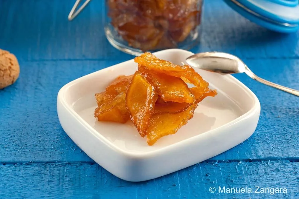 A serving of Mostarda Mantovana in a small white dish with a spoon.