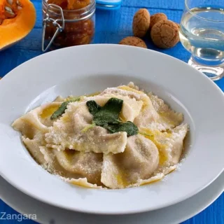 Close-up of Tortelli di Zucca with soft pumpkin filling and melted butter.