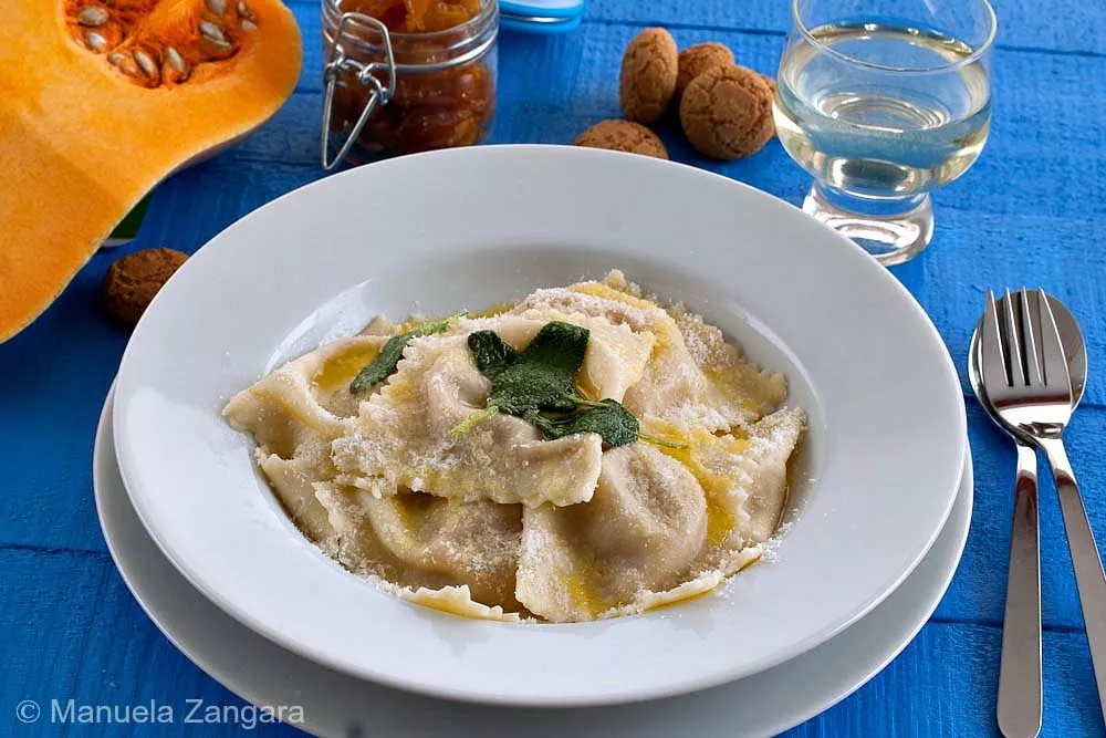 Close-up of Tortelli di Zucca with soft pumpkin filling and melted butter.