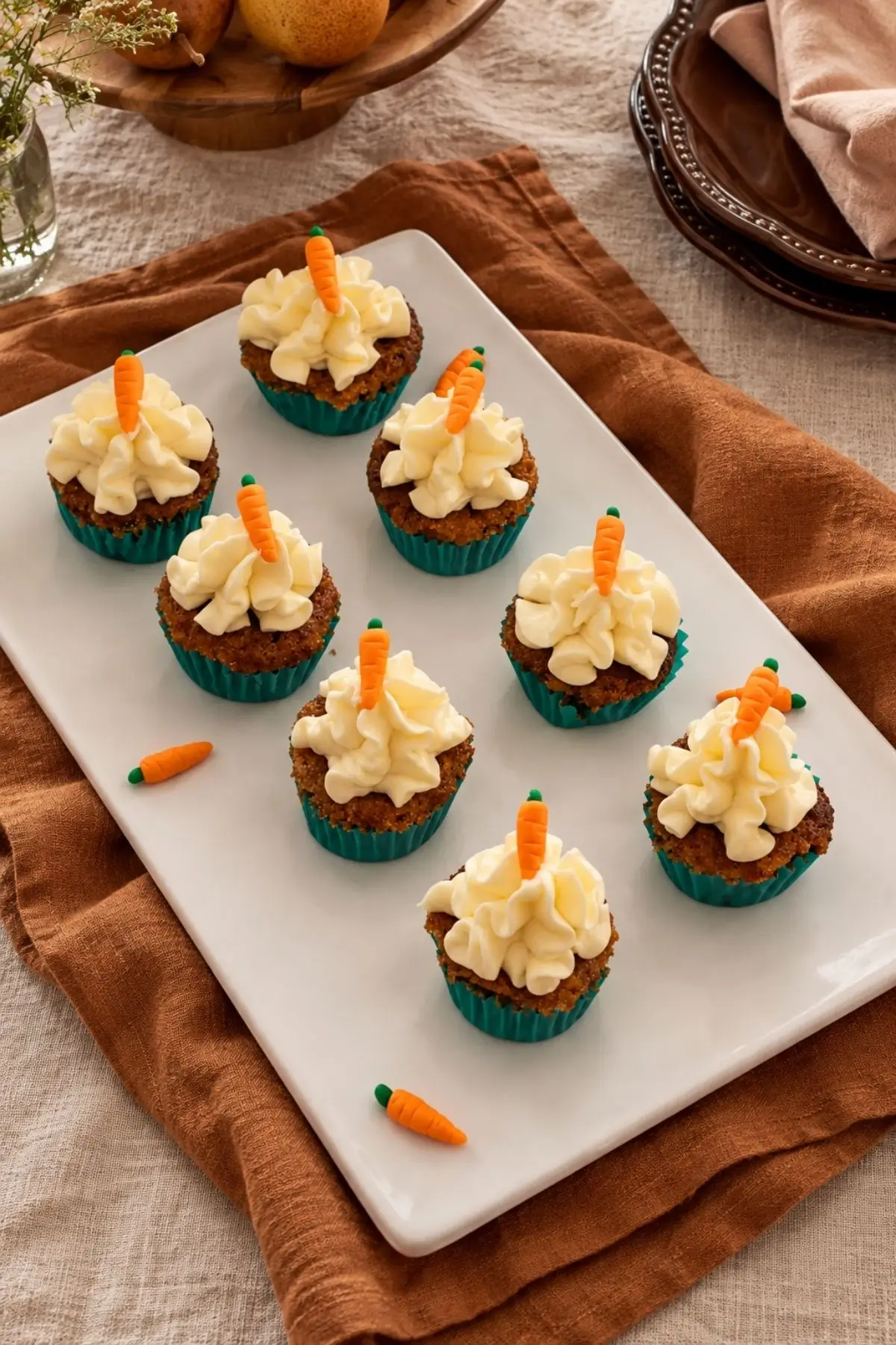 Carrot cupcakes decorated with miniature fondant carrots.