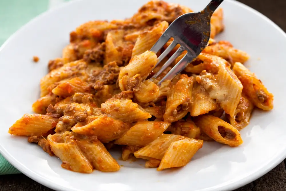 Portion of pasta al forno with béchamel sauce served on a plate.