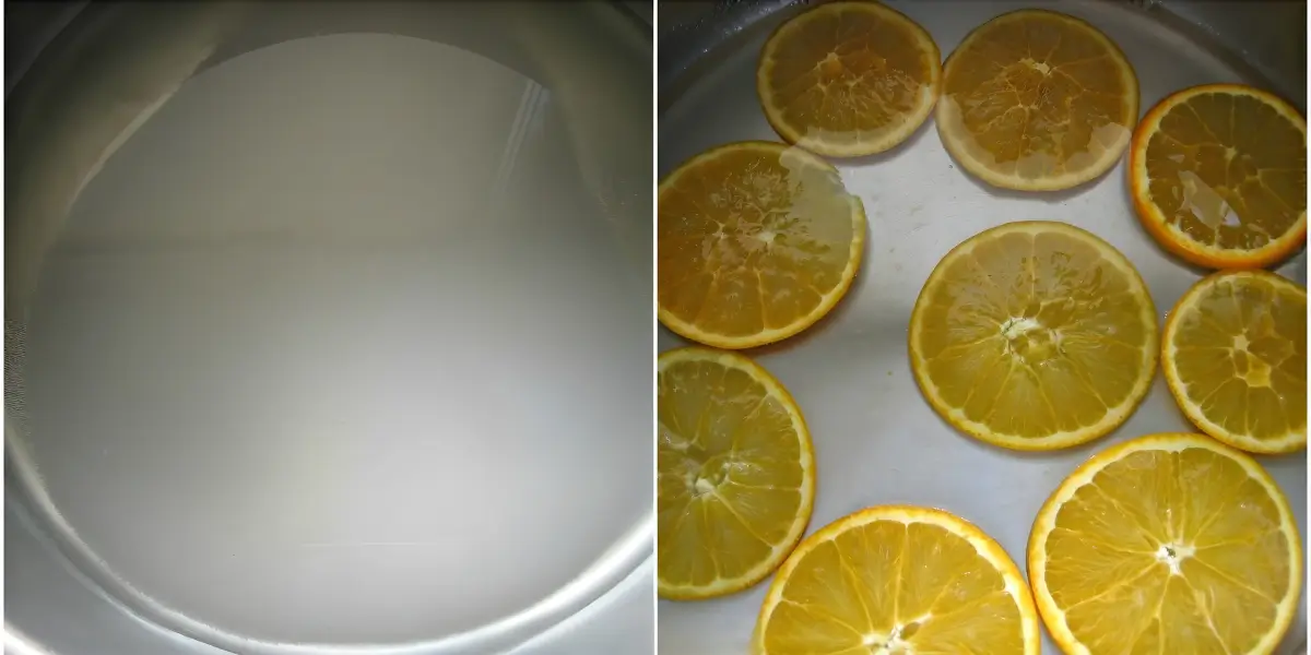 Thin orange slices simmering in sugar syrup during the candying process.