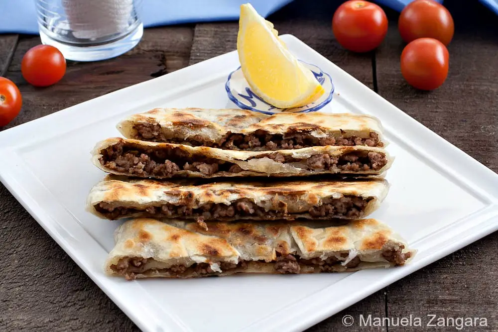 Golden, pan-cooked flatbread parcels served with lemon and cherry tomatoes.