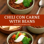 Chili con Carne with Beans served in a red pot with fresh toppings on a wooden board.