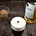 Finished Irish Coffee with whipped cream and a coffee bean on top.