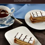 Finished mille-feuille slice on a white plate with a fork.