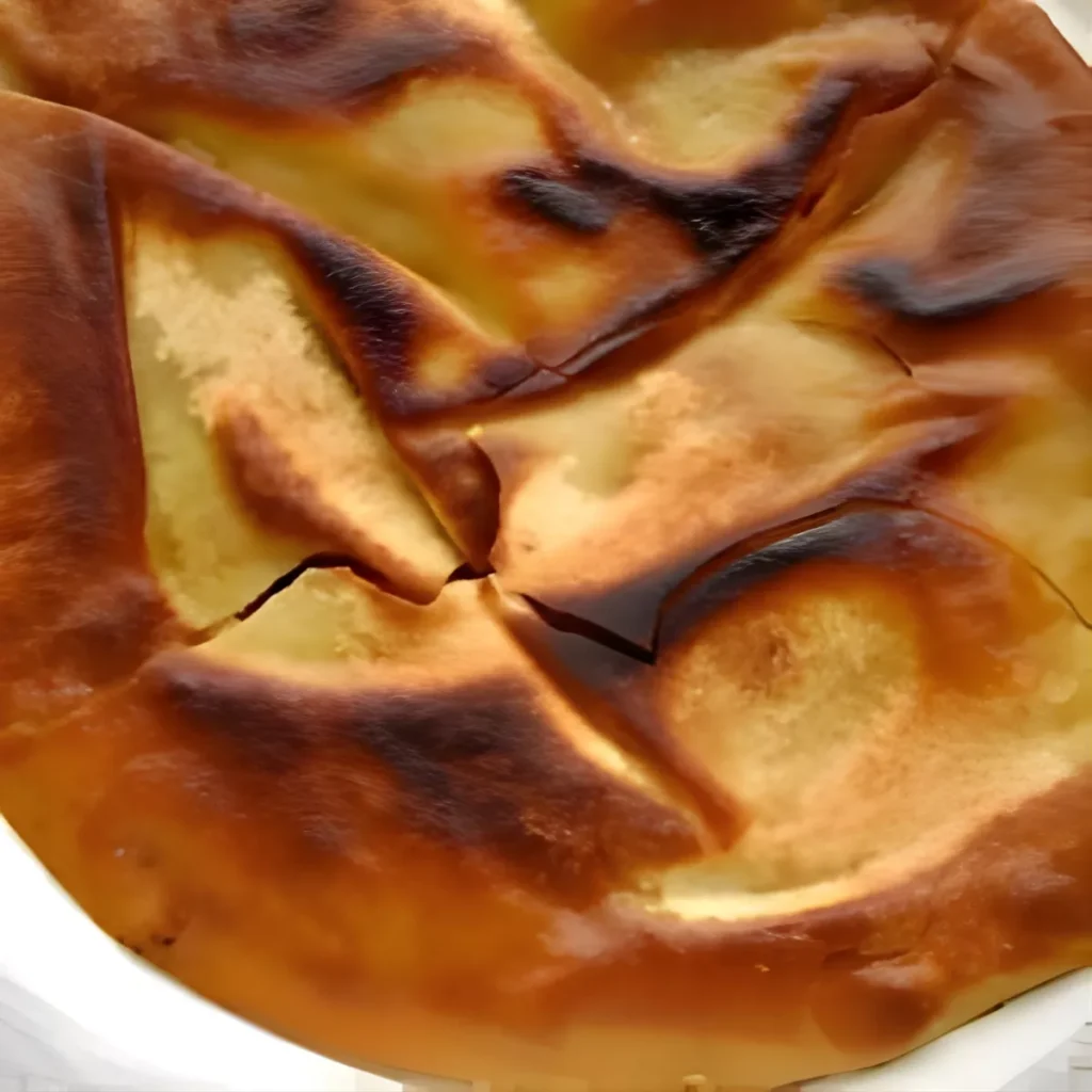 A close-up of crispy khubz bread, a key ingredient for Fattoush salad.