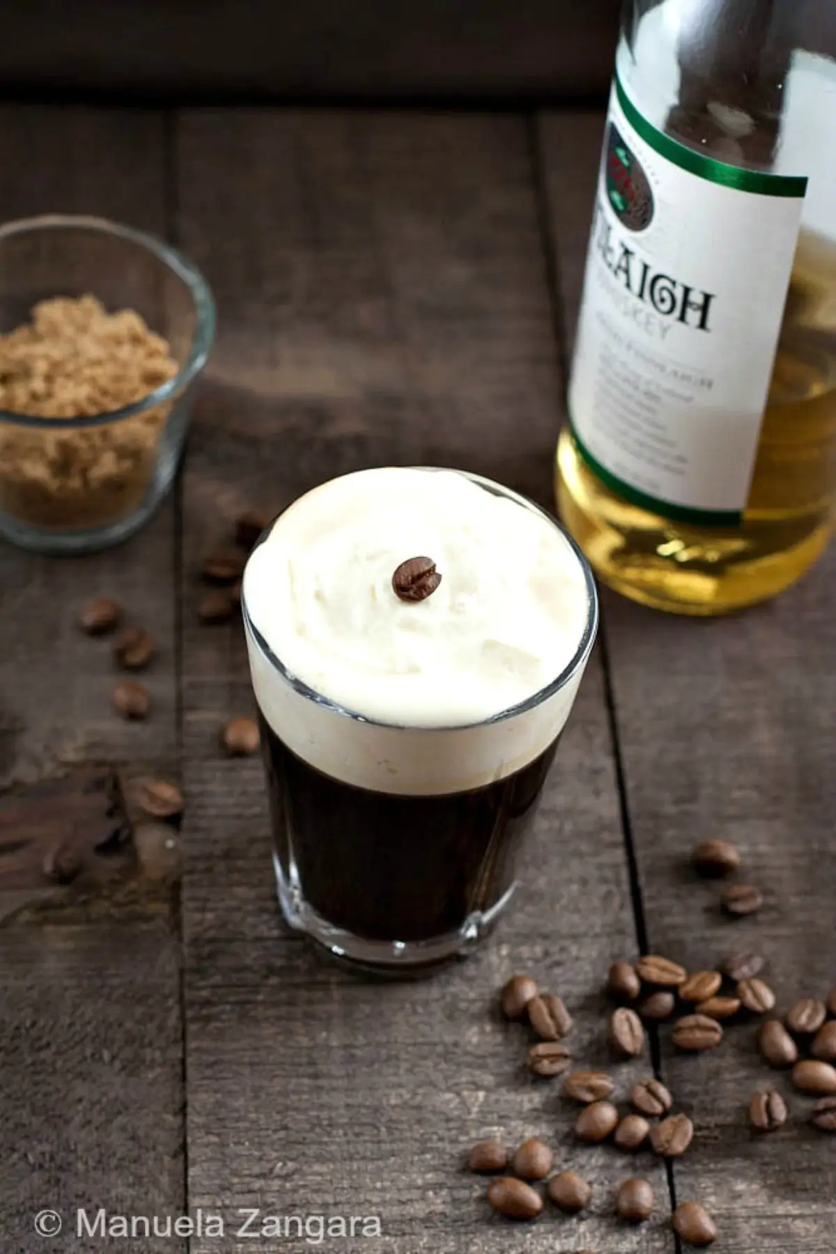 Hot coffee poured into a warm glass.
