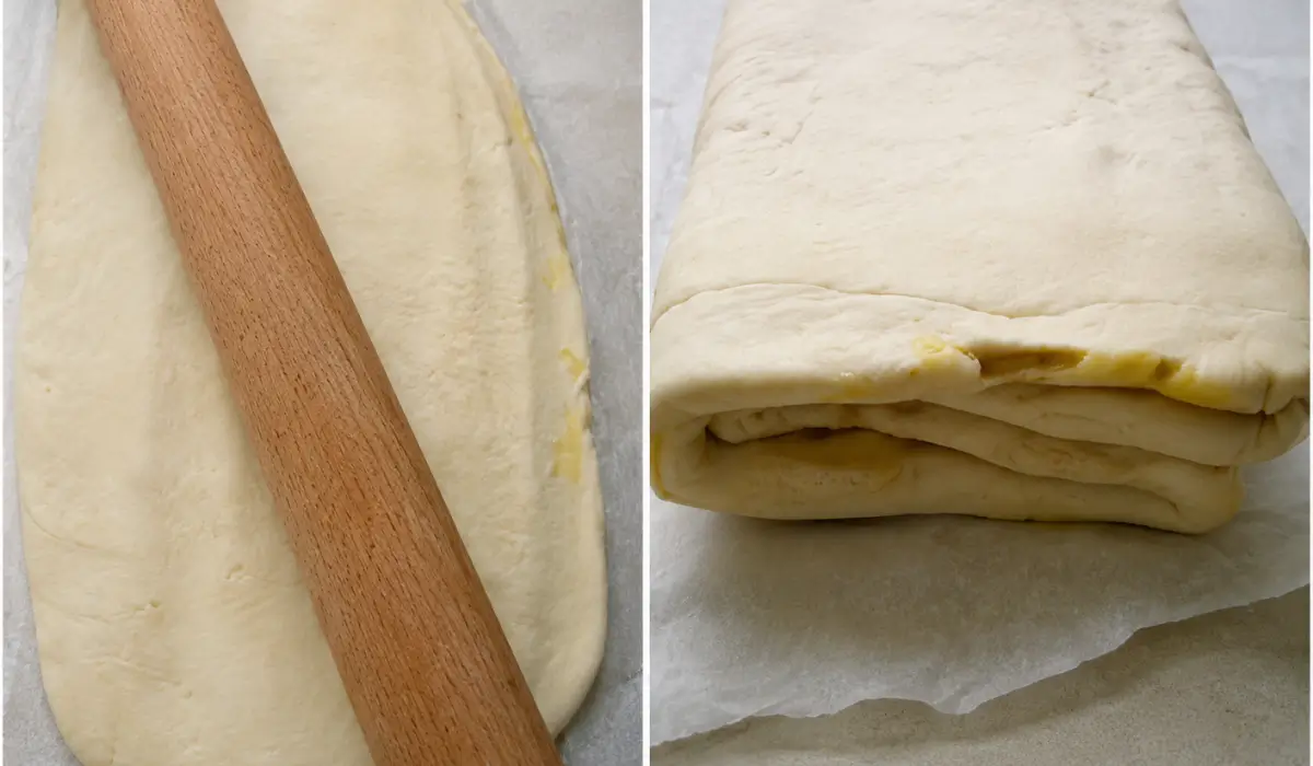 Puff pastry dough being rolled into a long rectangle and folded into layers during lamination.