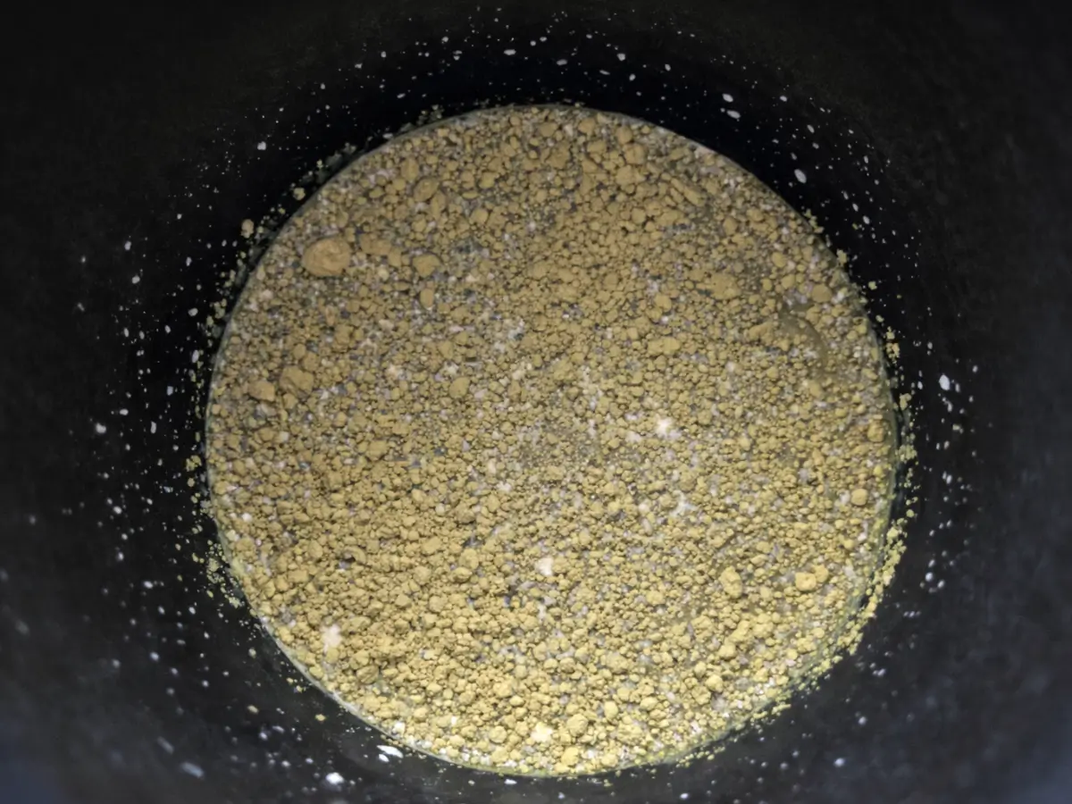 Freshly sifted matcha powder inside an electric frother bowl.