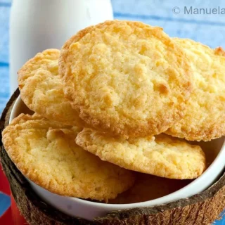 Close-up of golden, chewy coconut cookies in a bowl.