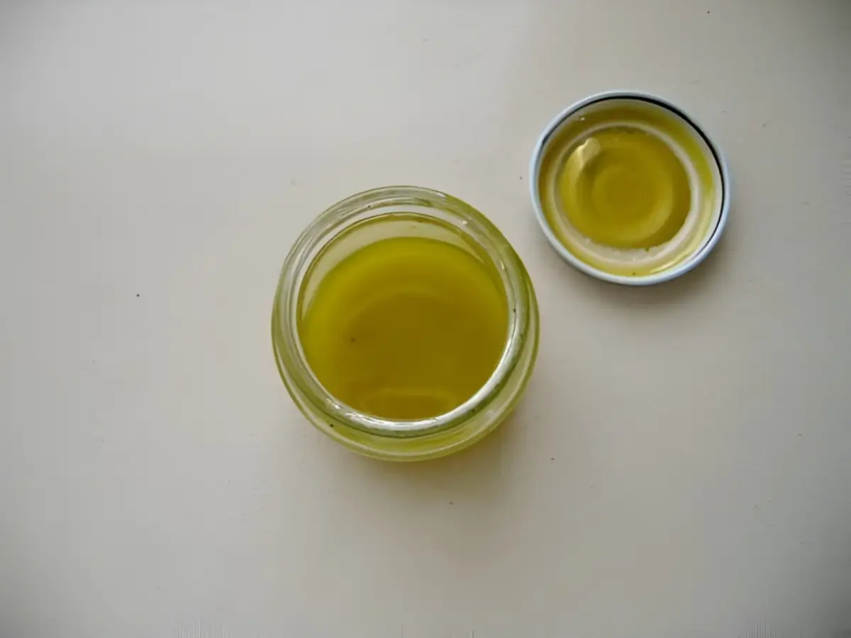 Lime and olive oil vinaigrette mixed in a small glass jar.