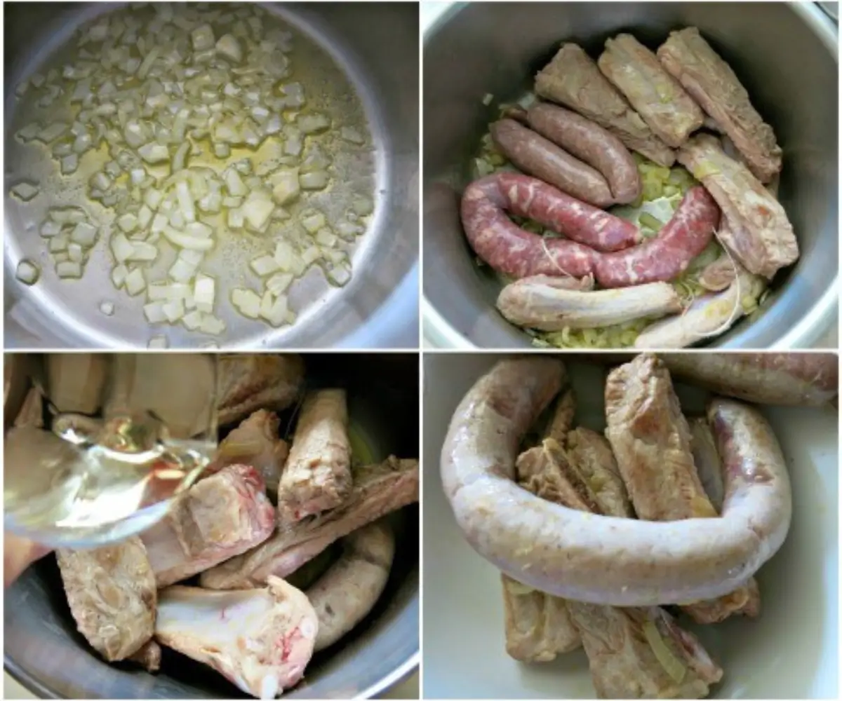 Pork ribs and sausages placed over cabbage in the pot before simmering.