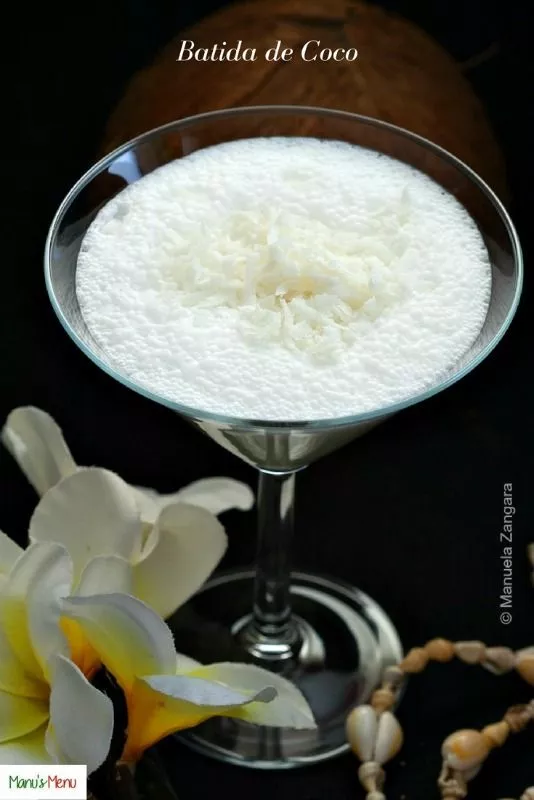 Batida de Coco cocktail topped with shredded coconut.