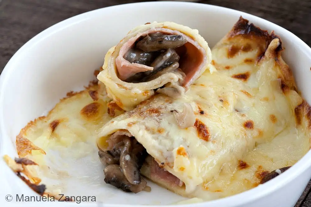 Open crêpe showing ham and mushroom filling after baking.