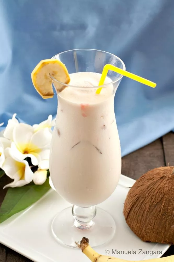 Creamy tropical cocktail with banana slice garnish.