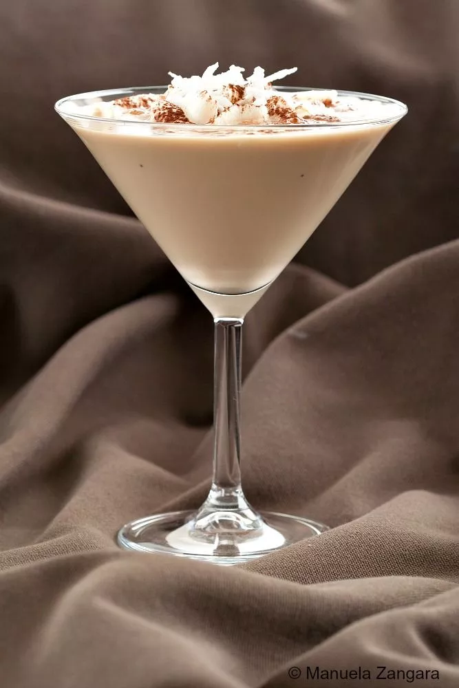 Dessert-style coconut cocktail in a martini glass.