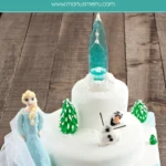 Full Frozen-themed cake view with Elsa, Olaf, sugar castle, and fondant trees.