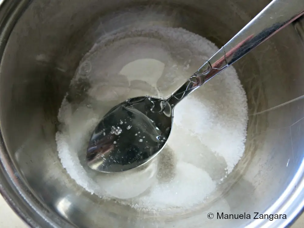 Sugar, water, and glucose syrup heating in a pot for the blue castle.
