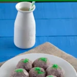 Plate of Troll Cookies arranged together, coated in cocoa sugar with green sugar moss.